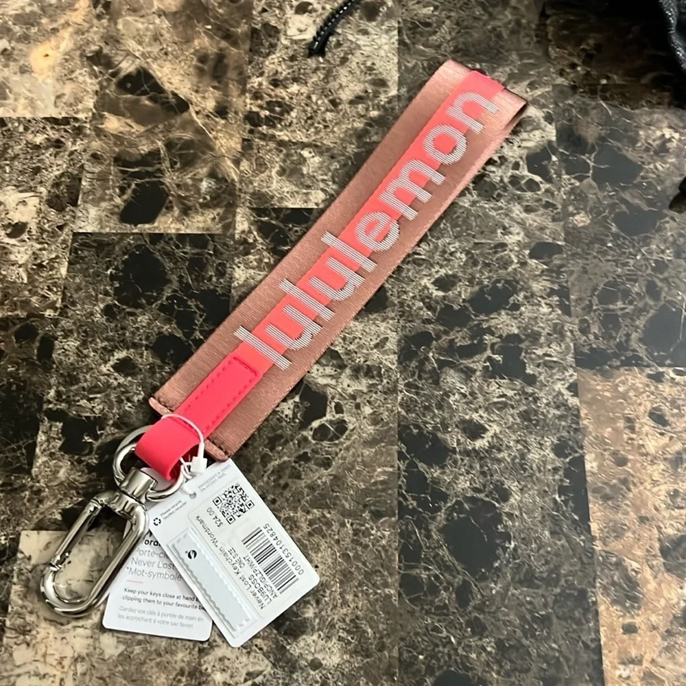 LULULEMON NEVER LOST KEYCHAIN ORANGE AND BROWN COLOR NWT